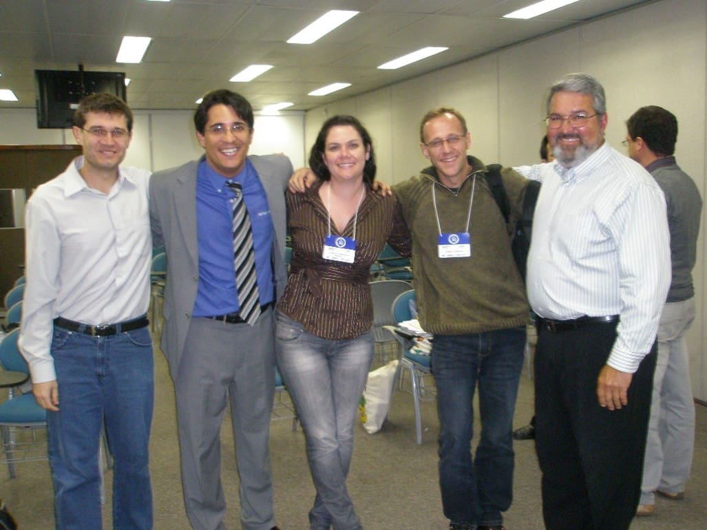 A group of people standing in an office.